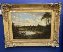 British School: 19th cent. Oil on canvas lake with figure in a boat, hills and trees beyond, in an