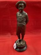 C. Kundonmann: Bronze figure of a boy smoking a Cheroot raised on a black marble base, signed C.