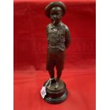 C. Kundonmann: Bronze figure of a boy smoking a Cheroot raised on a black marble base, signed C.