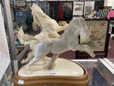 20th cent. Ceramics: Royal Worcester, Doris Lindner 'Galloping Horses' figurine, on treen base.