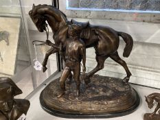 20th cent. Bronze figure of a racehorse and jockey on a marble base, signed and dated. 18½ins.