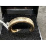 Jewellery: Yellow metal 6mm plain band, tests as 9ct gold. Ring size V½. Weight 14.8g.