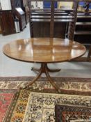 Regency mahogany circular breakfast table on single column and four splayed supports. 52ins.