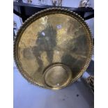 Islamic Metalware: Large round brass tray with crimpled edge engraved with Islamic script. 32½ins.