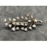 Jewellery: Yellow metal brooch in the form of a spray set with twenty-three old cut diamonds,