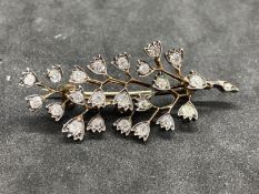 Jewellery: Yellow metal brooch in the form of a spray set with twenty-three old cut diamonds,