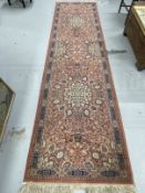 Carpets & Rugs: 20th cent. Keshan runner, red ground with stylised floral decoration and one