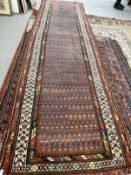 Carpets & Rugs: 19th cent. Persian runner, red ground with stylised floral decoration, four