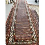 Carpets & Rugs: 19th cent. Persian runner, red ground with stylised floral decoration, four