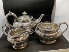 Hallmarked Silver: Georgian three piece tea set melon pattern body, gadroon border, C scroll handle.