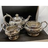 Hallmarked Silver: Georgian three piece tea set melon pattern body, gadroon border, C scroll handle.