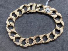 Hallmarked Jewellery: 9ct gold hammered curb link bracelet having a box snap with safety catch.