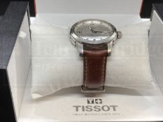 Watches: Stainless steel Tissot PR 200 on a brown leather strap.