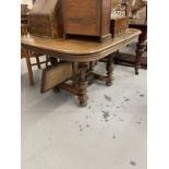 19th cent. Oak extending table with vase shaped turned supports, a cross stretcher with three fluted