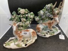 Derby figures of a stag and a doe c1765 reclining on low bases each with one fore hoof outstretched,