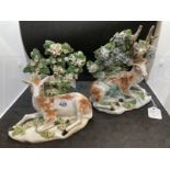 Derby figures of a stag and a doe c1765 reclining on low bases each with one fore hoof outstretched,