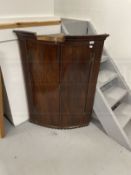 Late 18th cent. Mahogany bow front corner cupboard, moulded cornice above two doors flanked by