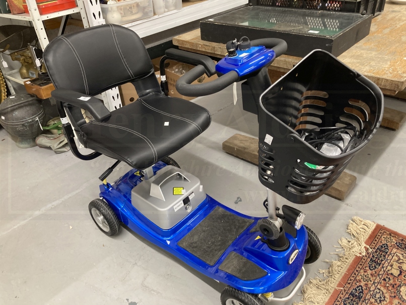 Battery powered 'Illusion' mobility scooter with forward and reverse gear, warning horn, reversing