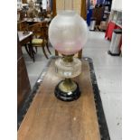 Oil lamp, Sharwoods Ltd etched shade, cut glass reservoir, brass column on a black ceramic base.