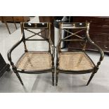 20th cent. Empire style armchairs ebonised wicker work seats with gilded decoration and crests to