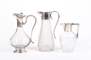 THREE MODERN STYLE CRYSTAL DECANTERS WITH METAL LIDS