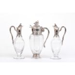 THREE ANTIQUE STYLE CRYSTAL DECANTERS WITH SILVER LIDS