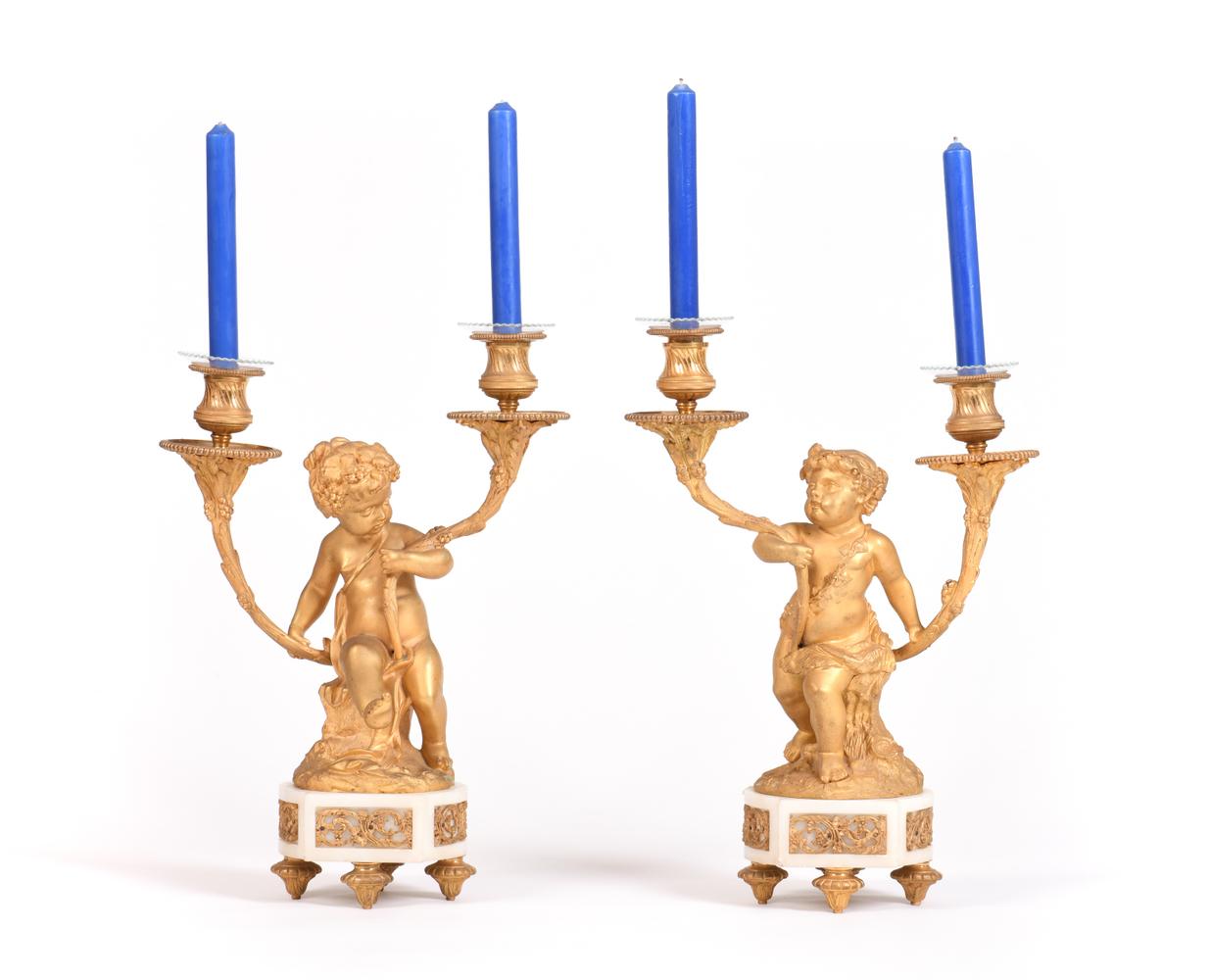 A PAIR OF LOUIS XVI STYLE GILT-BRONZE AND MARBLE PUTTI CANDLE HOLDERS, 19th century