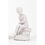 MANUFACTURE DE SÈVRES Sèvres biscuit figure group ‘A YOUNG GIRL SITTING WITH A BOW’