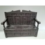 A Victorian Carved Oak Monks Bench H120cm x W145cm x D49cm