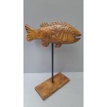 A Wooden Carved Fish On Stand