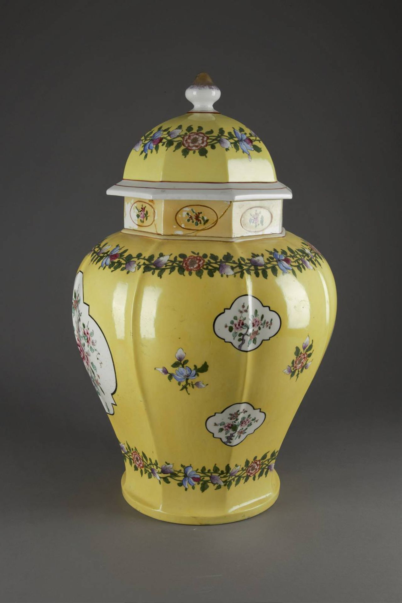 A YELLOW-GROUND FAMILLE ROSE JAR AND COVER