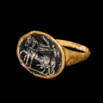 A Roman Gold Finger Ring with an Intaglio of Nike Riding a Chariot Ring size 11x13mm; Diameter of in