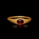 A Roman Gold and Garnet Finger Ring Ring size 10x13mm; Diameter of garnet 3/16 inch (0.48 cm).