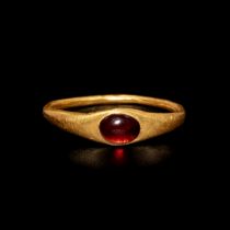 A Roman Gold and Garnet Finger Ring Ring size 10x13mm; Diameter of garnet 3/16 inch (0.48 cm).