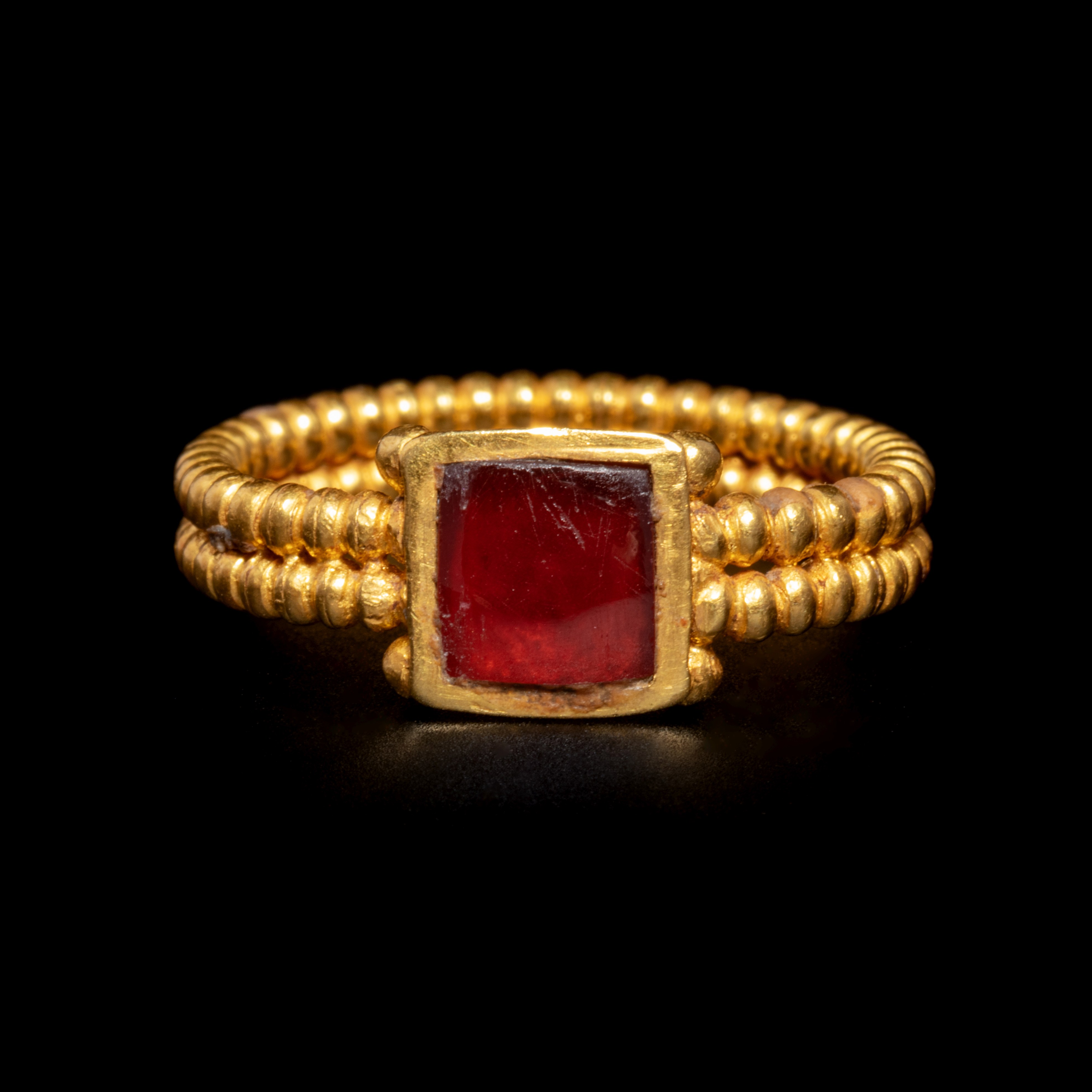 A Roman Gold and Garnet Finger Ring with Cabochon Ring size 3 1/3; Length of garnet 1/4 inch (0.5 cm