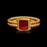 A Roman Gold and Garnet Finger Ring with Cabochon Ring size 3 1/3; Length of garnet 1/4 inch (0.5 cm