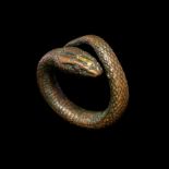 An Egyptian Gilt-Bronze Snake Ring Ring size 9; Diameter 1 inch (3 cm).
