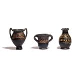 Three Xenon-Ware Miniature Black-Glazed Kantharoi  Height 2 3/4 inches (7 cm).