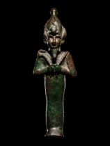 An Egyptian Bronze Osiris with Silver Inlaid Eyes Height 6 inches (15.5 cm).