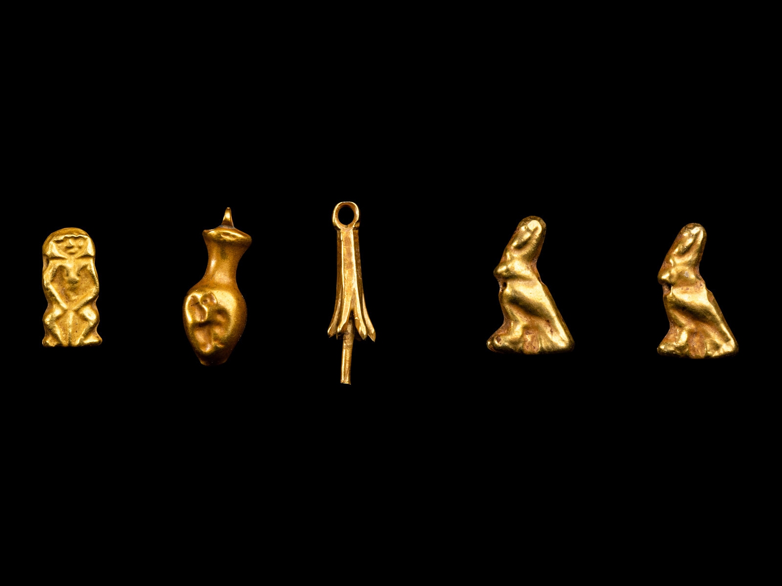 Five Egyptian Gold Amulets including Papyrus, Nefer, Bes and Horus Height of largest 1/2 inch (1.27