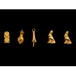 Five Egyptian Gold Amulets including Papyrus, Nefer, Bes and Horus Height of largest 1/2 inch (1.27