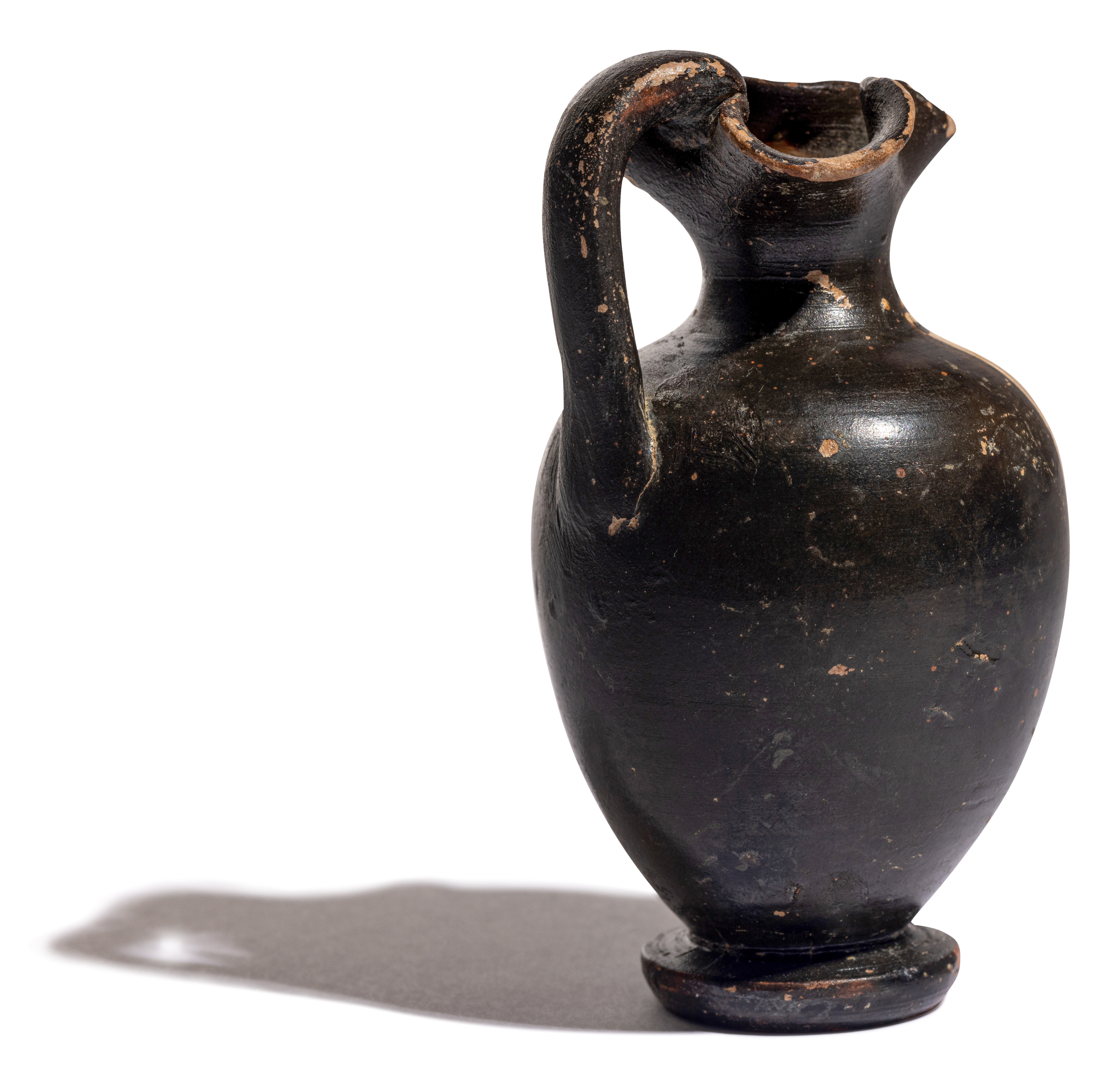 A Greek Black-Figured Trefoil Oinochoe Height 3 3/4 inches (10 cm). - Image 8 of 12