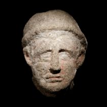 An Etruscan Over-Lifesized Nenfro Portrait Head of a Man Height 12 1/2 inches (31.75 cm).