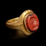 A Roman Gold and Red Jasper Finger Ring Engraved with the Bust of a Man Ring size 6 1/2; Diameter of
