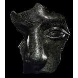 A Roman Bronze Fragmentary Face Height 5 inches (13 cm).
