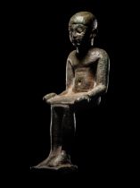 An Egyptian Bronze Imhotep with Silver Inlaid Eyes Height 4 1/4 inches (11 cm).