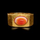 A Roman Gold Finger Ring with Banded Carnelian Cabochon Ring size 3 1/2; Diameter of carnelian 1 inc