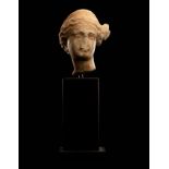 A Roman Marble Head of a Woman Height 2 3/16 inches (6 cm).
