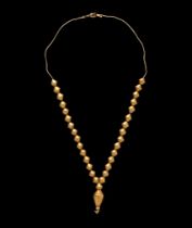 An Achaemenid Hollow Gold Bead Necklace Length 14 3/8 inches (36.5 cm).