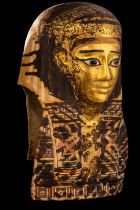 An Egyptian Gilt Cartonnage Mummy Mask Height 18 1/2 inches (47 cm).